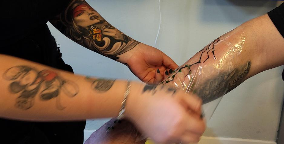 Tatov&oslash;r dekker til ei ny tatovering med det som heiler "second skin".