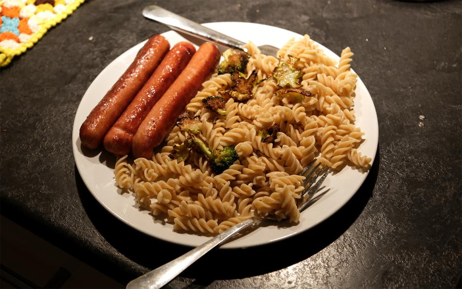 Tre p&oslash;lser, pasta, og frossen brokkoli p&aring; en tallerken.