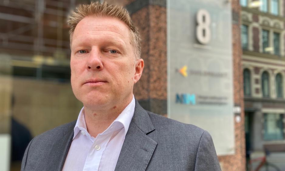 Mann foran skilt hvor det st&aring;r Sivilombudet