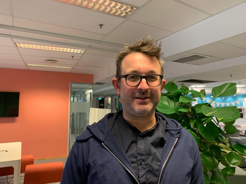 Bilde av Hallvar Lavoll som st&aring;r i et kontorlandskap