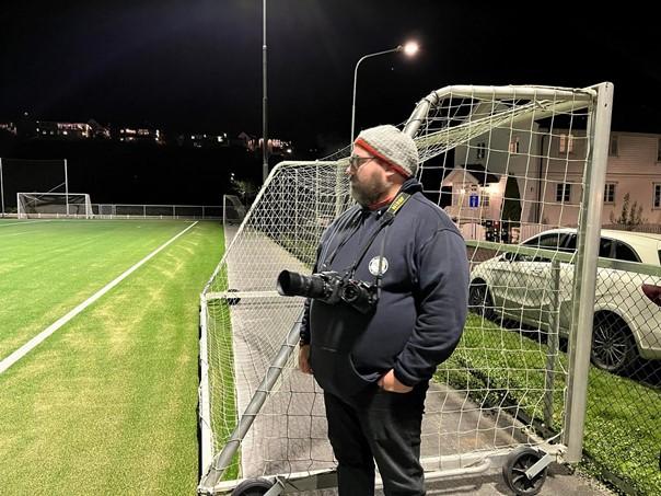 Marius Helg&aring; st&aring;r p&aring; sidelinjen og forbereder seg p&aring; &aring; ta bilder av kampen.