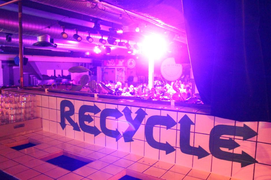 RECYCLED st&aring;r i store bokstaver, og bak er et fullstappa dansegulv. 