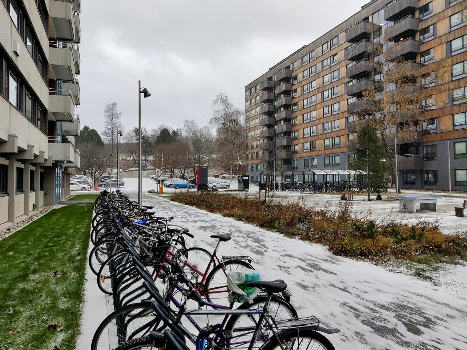 Sykler p&aring; stativ og sn&oslash; p&aring; bakken