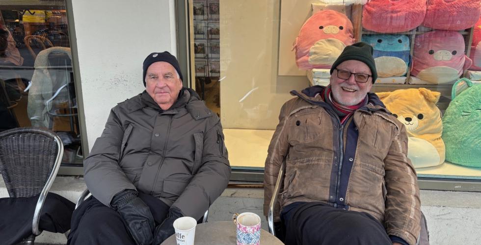 To menn med lue og boblejakke i stoler utenfor Kaffebrenneriet p&aring; Gr&uuml;nerl&oslash;kka