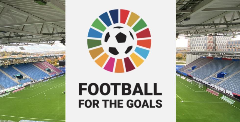 Bilde av en stadio, hvor det er limt p&aring; en hvit boks over med logoen til Football for the goals. Det er b&aelig;rekraftsfargene i en sirkel rundt en fotball.