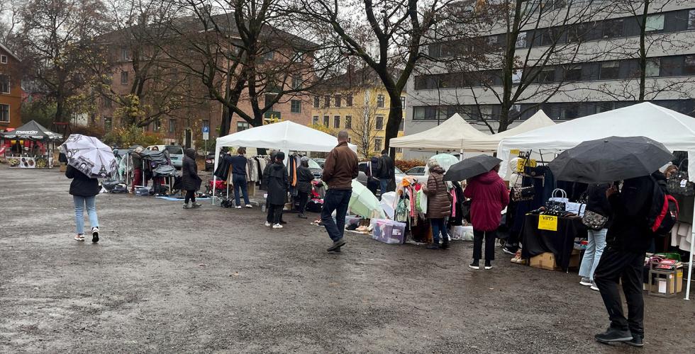 Bildet viser Vestkanttorget og bes&oslash;kende og det regner