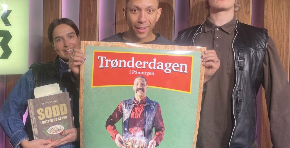 Tre mennesker som holder et skilt de er klare for tr&oslash;nder dagen